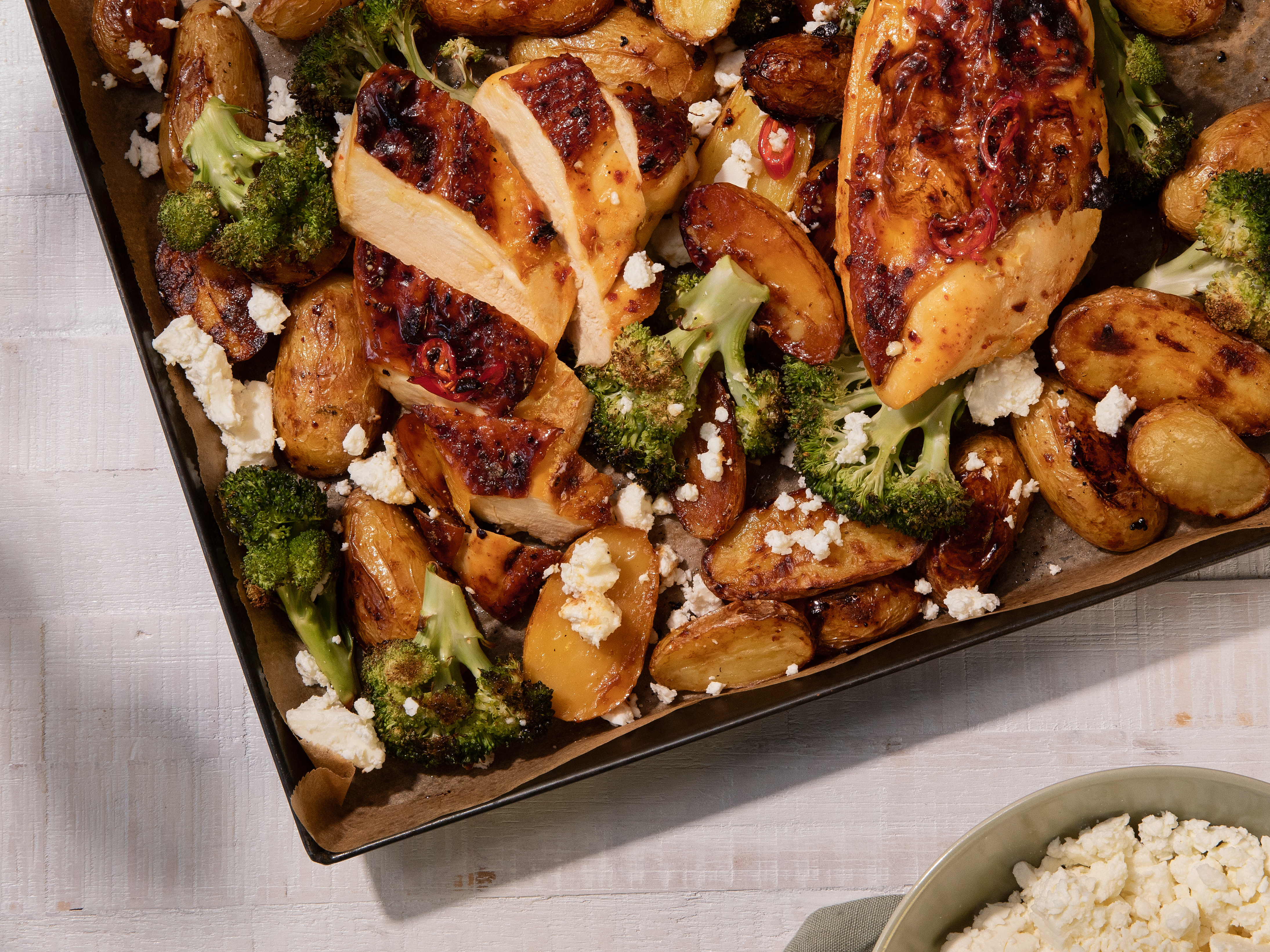 Hot honey chicken tray bake with potatoes, broccoli and feta